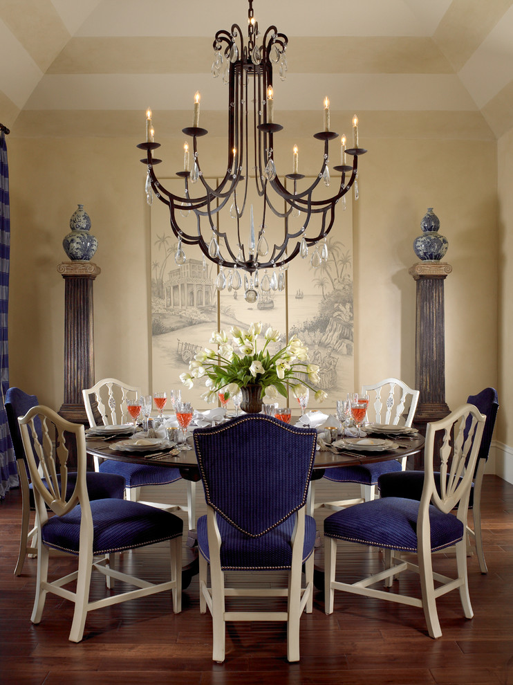 Photo of a traditional dining room in Miami with beige walls and dark hardwood floors.