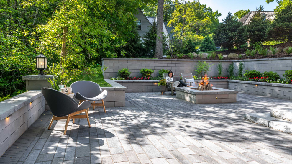 Inspiration for a transitional backyard patio in Other with concrete pavers, a fire feature and no cover.