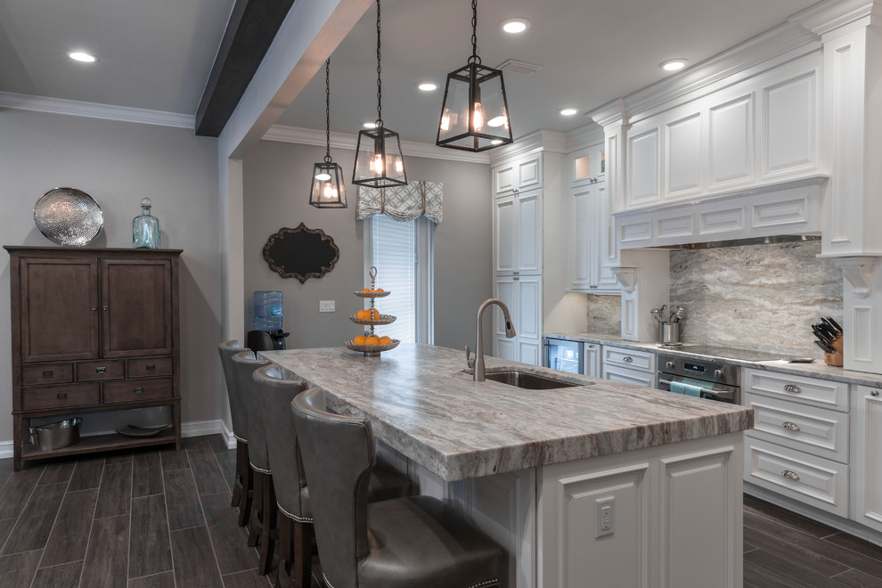 Inspiration for a large transitional l-shaped open plan kitchen in Tampa with an undermount sink, raised-panel cabinets, white cabinets, granite benchtops, multi-coloured splashback, stone slab splashback, stainless steel appliances, porcelain floors and with island.