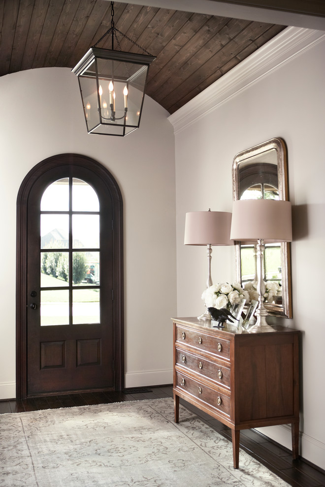 Mid-sized traditional foyer in Other with dark hardwood floors, a single front door and a dark wood front door.