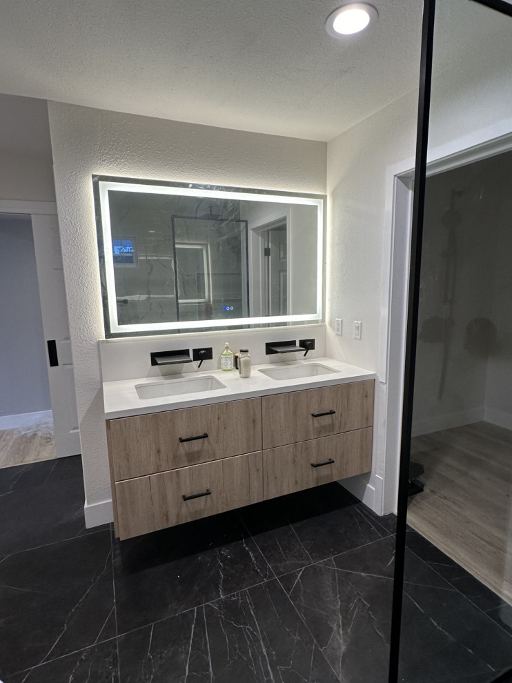 Design ideas for a large contemporary master bathroom in Los Angeles with flat-panel cabinets, brown cabinets, a freestanding tub, a curbless shower, a one-piece toilet, white tile, marble, white walls, marble floors, an undermount sink, quartzite benchtops, black floor, an open shower, white benchtops, a shower seat, a double vanity and a floating vanity.