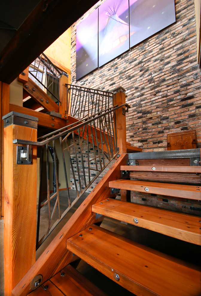 Design ideas for a mid-sized wood u-shaped staircase in Calgary with open risers and metal railing.