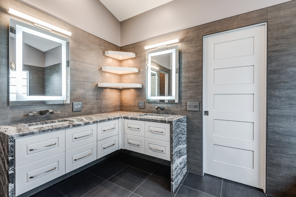 Freestanding bathtub - large modern master gray tile and ceramic tile ceramic tile and gray floor freestanding bathtub idea in Chicago with raised-panel cabinets, white cabinets, a wall-mount toilet, gray walls, an undermount sink, quartzite countertops and a hinged shower door