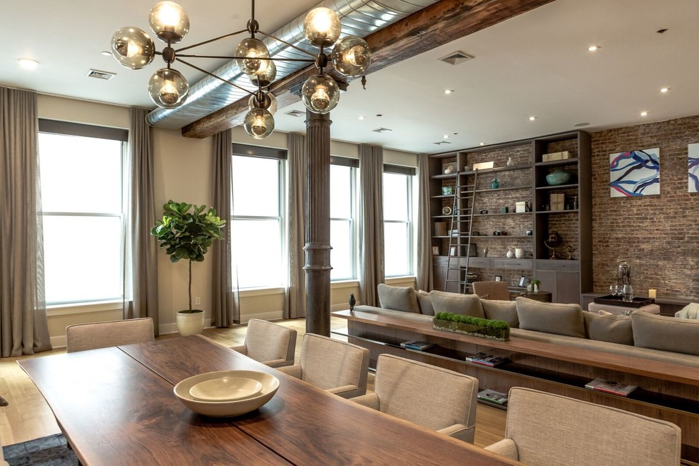 Expansive contemporary open plan dining in New York with beige walls, light hardwood floors and no fireplace.