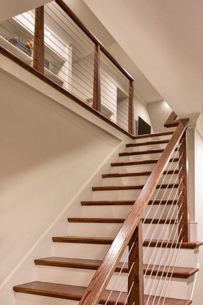 Inspiration for an arts and crafts wood straight staircase in Other with wood risers and cable railing.