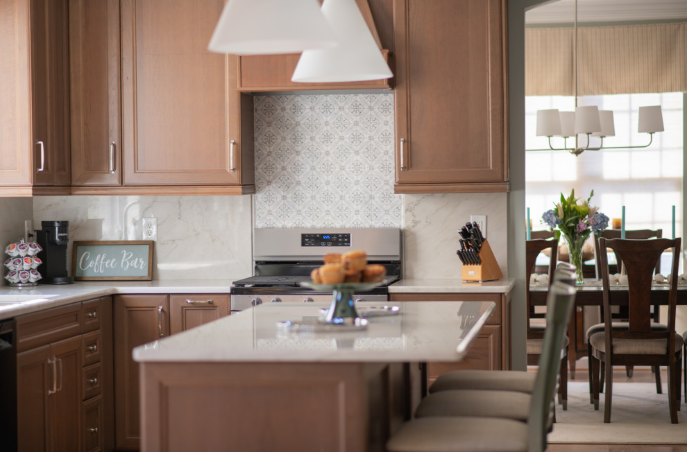 Eat-in kitchen - mid-sized coastal light wood floor eat-in kitchen idea in Baltimore with recessed-panel cabinets, medium tone wood cabinets, quartzite countertops, stainless steel appliances, an island and white countertops