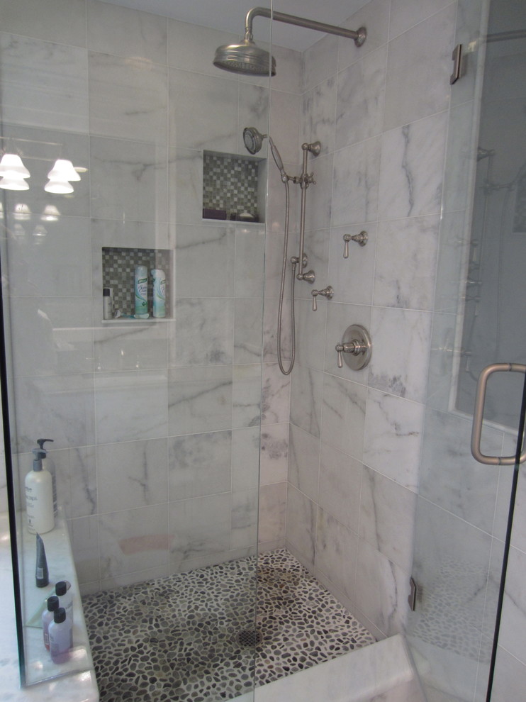 Photo of a large transitional master bathroom in New York with beaded inset cabinets, white cabinets, an undermount tub, a corner shower, white tile, stone tile, grey walls, marble floors, an undermount sink and engineered quartz benchtops.
