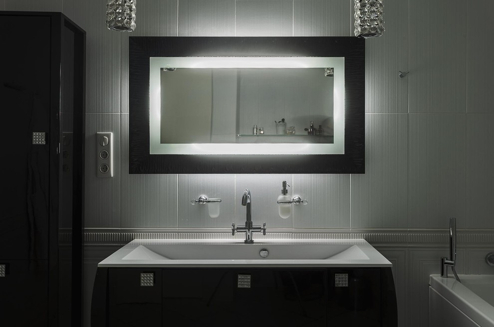 Inspiration for a mid-sized contemporary master bathroom in Moscow with flat-panel cabinets, black cabinets, an alcove tub, an alcove shower, a wall-mount toilet, white tile, ceramic tile, white walls, ceramic floors, a wall-mount sink, solid surface benchtops, white floor and a hinged shower door.
