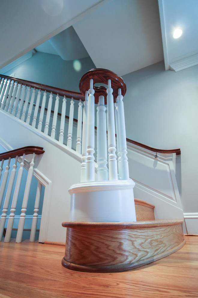 Expansive traditional wood u-shaped staircase in DC Metro with wood risers and wood railing.