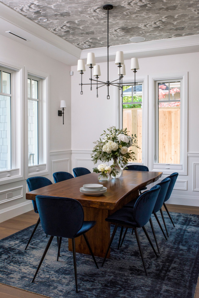 Photo of a transitional separate dining room in Vancouver with white walls, brown floor, wallpaper, decorative wall panelling and light hardwood floors.