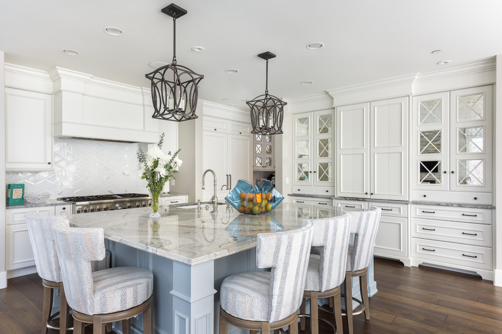 Large transitional l-shaped open plan kitchen in Orange County with white cabinets, marble benchtops, stainless steel appliances, with island, brown floor, grey benchtop, an undermount sink, shaker cabinets, white splashback and cork floors.