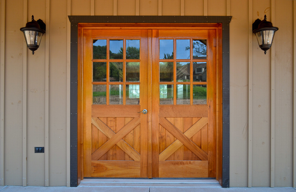 Example of a mid-sized transitional front door design with a medium wood front door
