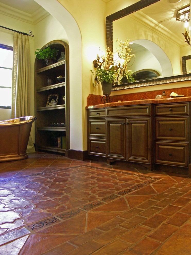 This is an example of a traditional bathroom in Barcelona with terra-cotta tile and terra-cotta floors.