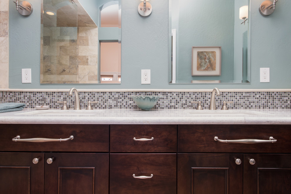 Inspiration for a large transitional master bathroom in Phoenix with an undermount sink, raised-panel cabinets, dark wood cabinets, granite benchtops, a curbless shower, gray tile, stone tile, blue walls and ceramic floors.