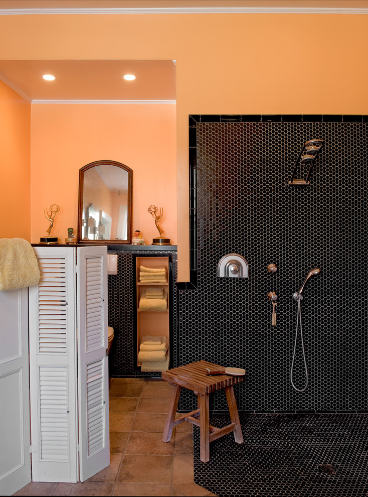 This is an example of a traditional bathroom in New York with an open shower, black tile, mosaic tile, orange walls and an open shower.