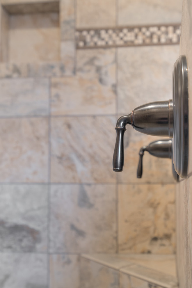 Home design - mid-sized transitional master multicolored tile ceramic tile home design idea with raised-panel cabinets, beige cabinets, a two-piece toilet, beige walls, an undermount sink and quartz countertops