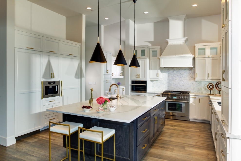 Large transitional u-shaped brown floor eat-in kitchen photo in Sacramento with an undermount sink, shaker cabinets, white cabinets, quartz countertops, white backsplash, mosaic tile backsplash, stainless steel appliances, an island and white countertops