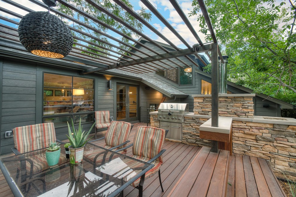 Mid-sized modern backyard patio in Denver with an outdoor kitchen, decking and a pergola.