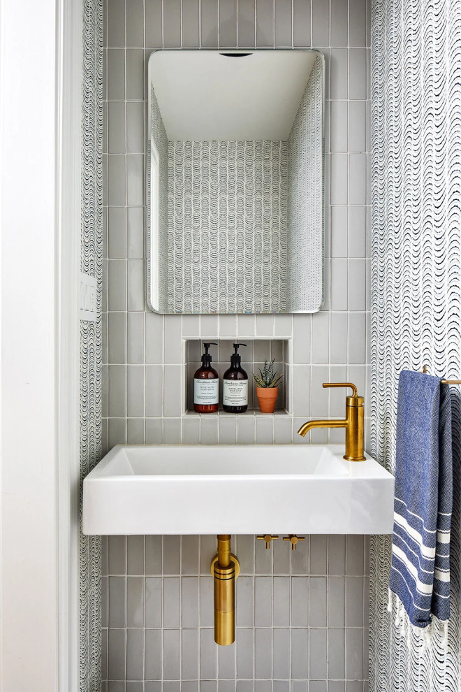 Example of a small trendy white tile and ceramic tile powder room design in Other