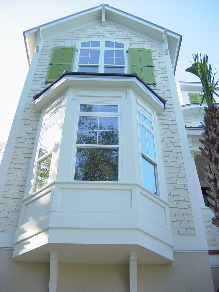 Inspiration for a large arts and crafts two-storey white exterior in Other with vinyl siding.