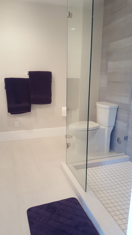 This is an example of a mid-sized traditional master bathroom in Vancouver with shaker cabinets, white cabinets, an alcove shower, a two-piece toilet, beige tile, ceramic tile, beige walls, solid surface benchtops, ceramic floors, white floor and an open shower.