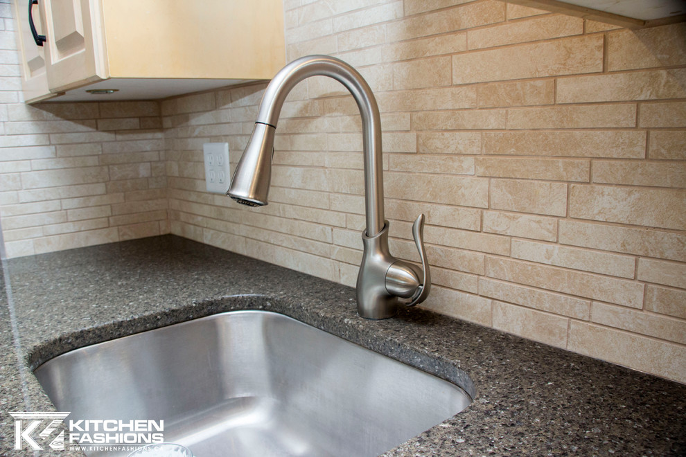 Example of a large trendy u-shaped porcelain tile eat-in kitchen design with an undermount sink, raised-panel cabinets, light wood cabinets, quartzite countertops, multicolored backsplash, porcelain backsplash, stainless steel appliances and a peninsula