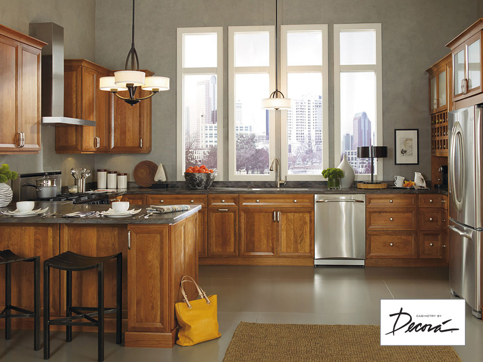 Small l-shaped eat-in kitchen photo with medium tone wood cabinets, stainless steel appliances, a peninsula and gray countertops
