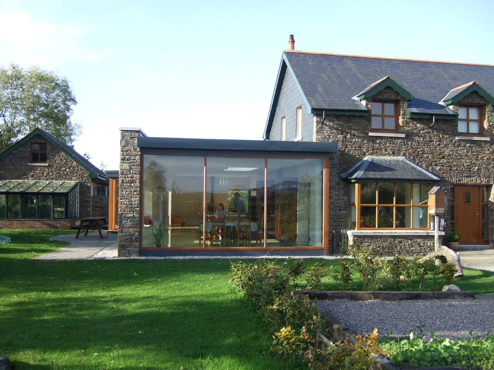 Photo of a transitional exterior in Cork with stone veneer.