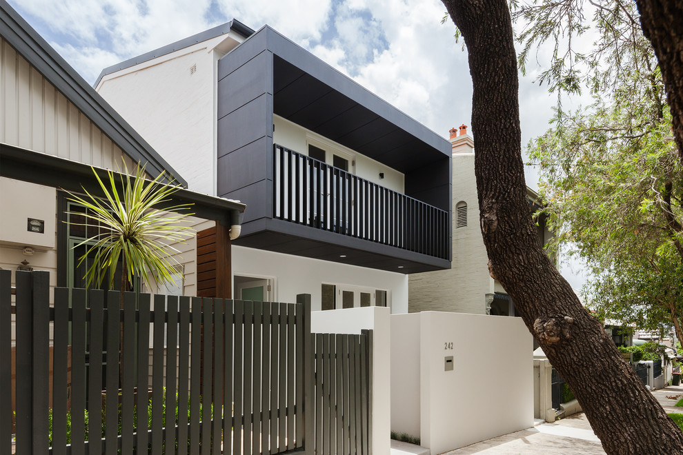 Photo of a contemporary two-storey white house exterior in Sydney with a gable roof.
