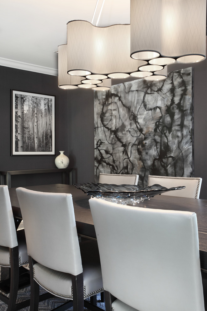 This is an example of a large contemporary separate dining room in New York with grey walls, dark hardwood floors and no fireplace.