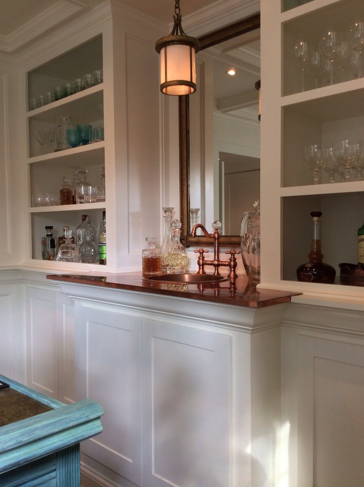 Large transitional galley home bar in Indianapolis with a drop-in sink, recessed-panel cabinets, wood benchtops, white splashback, dark hardwood floors and brown benchtop.