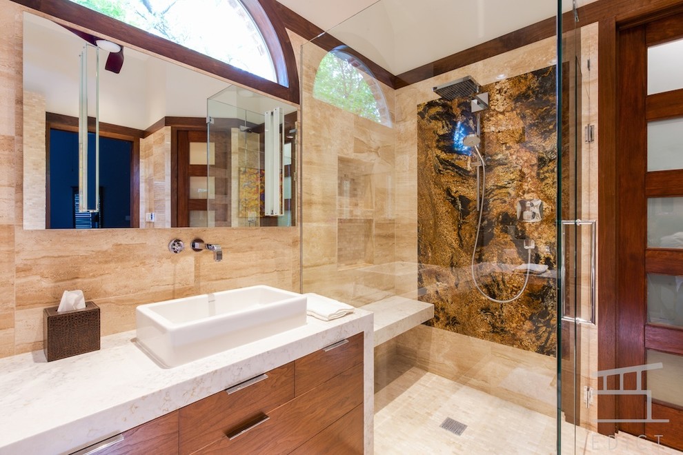 Mid-sized modern master bathroom in Dallas with a wall-mount sink, flat-panel cabinets, medium wood cabinets, engineered quartz benchtops, a freestanding tub, a corner shower, a wall-mount toilet, beige tile, stone tile, beige walls and marble floors.
