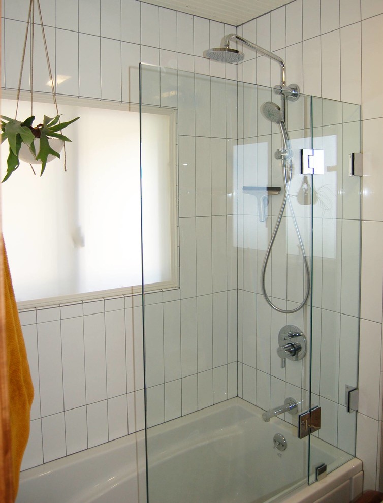 Transitional master white tile ceramic tile and multicolored floor tub/shower combo photo with open cabinets, a two-piece toilet, gray walls, a pedestal sink and a hinged shower door