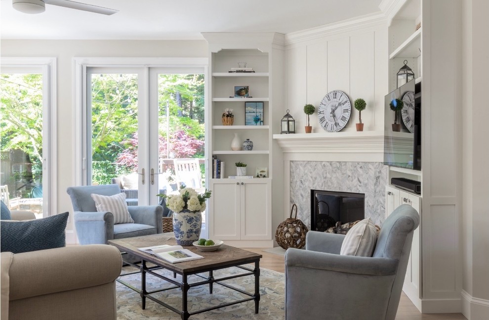 Inspiration for a mid-sized transitional light wood floor and beige floor family room remodel in San Francisco with gray walls, a corner fireplace, a wood fireplace surround and a wall-mounted tv