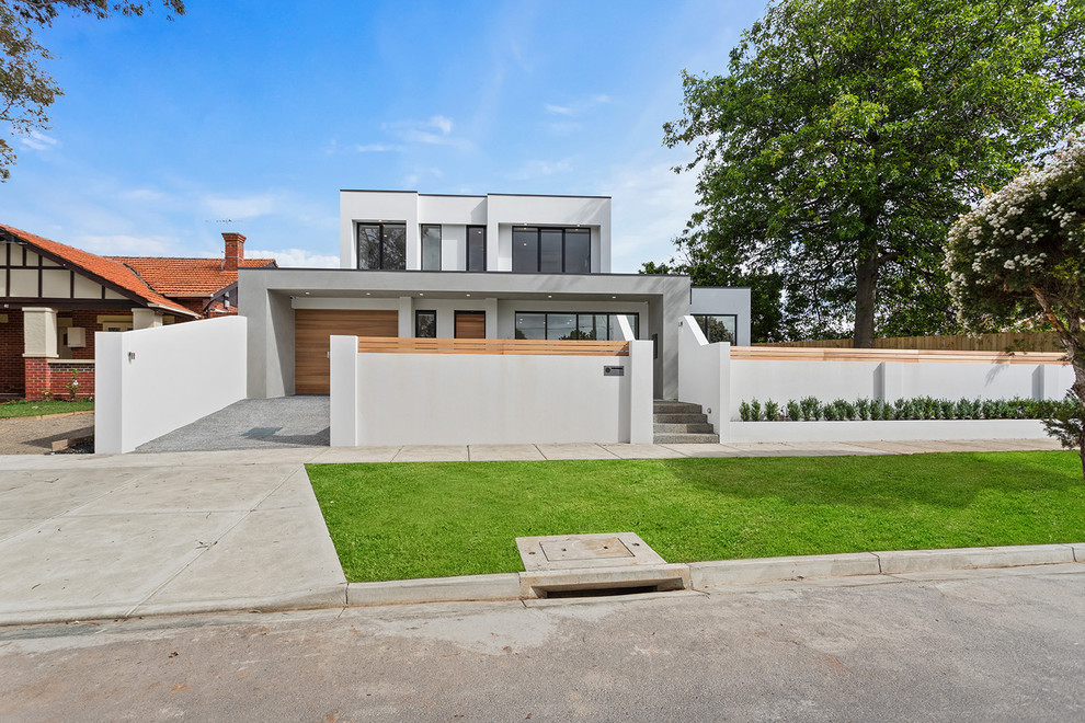 This is an example of a mid-sized contemporary two-storey brick grey townhouse exterior in Melbourne with a flat roof and a metal roof.