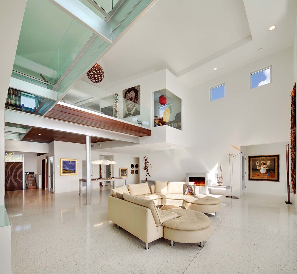 Expansive modern living room in Tampa with white walls, a ribbon fireplace and white floor.