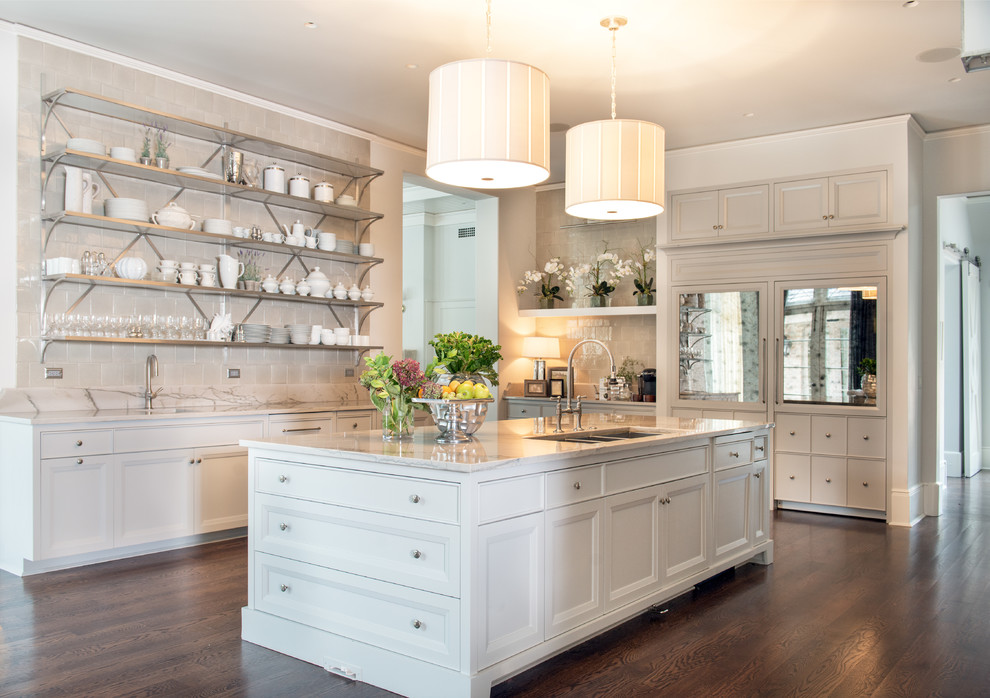 Photo of a small u-shaped kitchen pantry in Chicago with an undermount sink, open cabinets, white cabinets, marble benchtops, beige splashback, ceramic splashback, stainless steel appliances and with island.