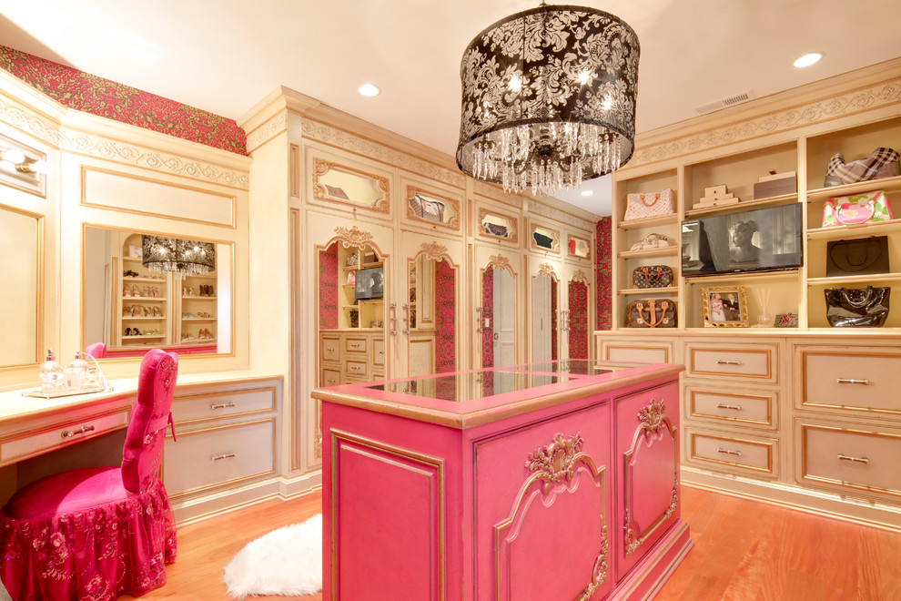 Inspiration for a traditional women's dressing room in Other with beige cabinets and medium hardwood floors.