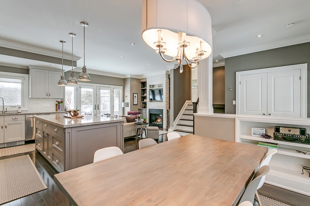 Small transitional dark wood floor and brown floor great room photo in Toronto with beige walls and no fireplace