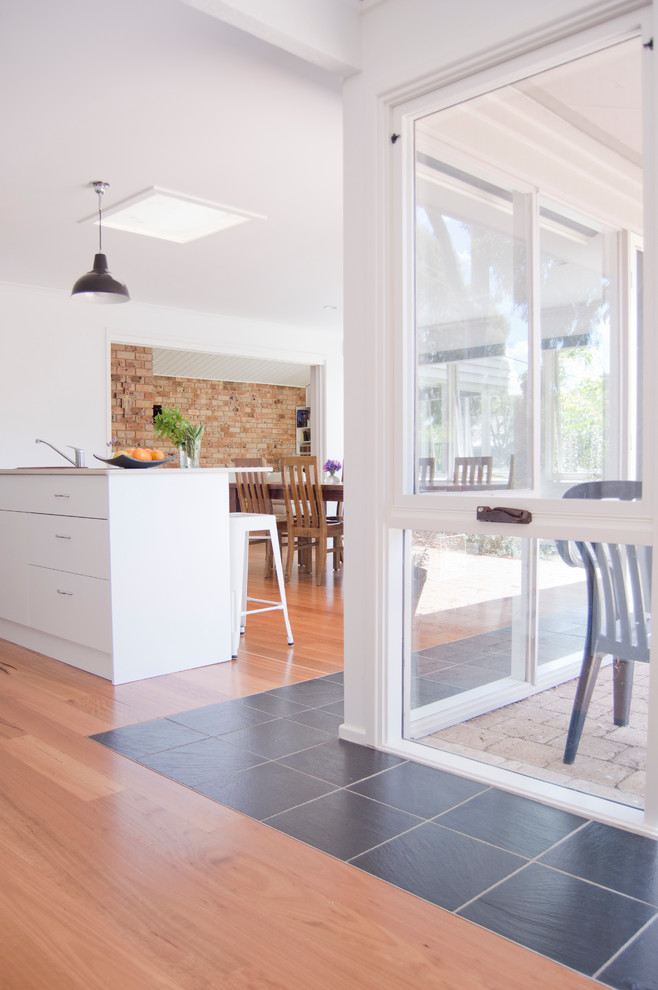 This is an example of a contemporary sunroom in Wollongong with slate floors.