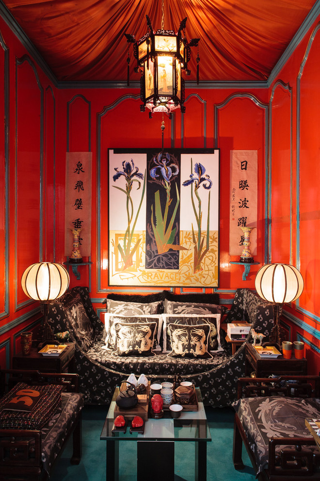 Photo of a mid-sized asian enclosed living room in Paris with red walls, carpet, no fireplace and no tv.