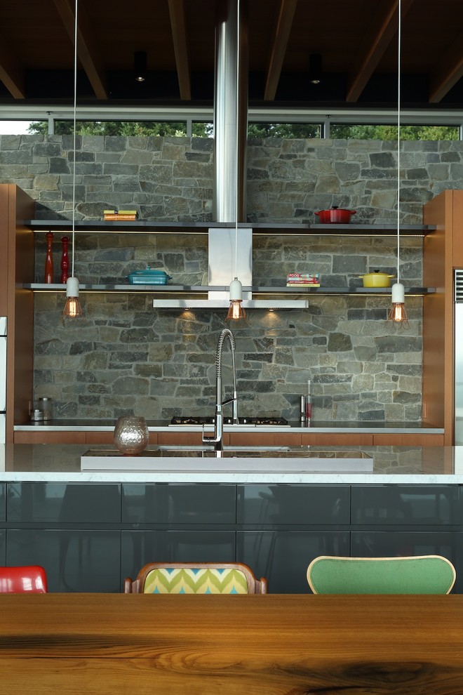 Open concept kitchen - mid-sized contemporary galley open concept kitchen idea in Vancouver with an undermount sink, flat-panel cabinets, brown cabinets, gray backsplash, stainless steel appliances and an island