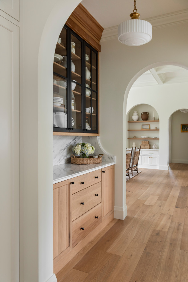 Inspiration for a small transitional light wood floor and brown floor hallway remodel in St Louis with white walls