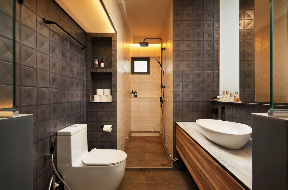 Photo of an industrial 3/4 bathroom in Singapore with flat-panel cabinets, medium wood cabinets, an open shower, a one-piece toilet, black tile, white tile, black walls, a vessel sink, black floor, an open shower and grey benchtops.