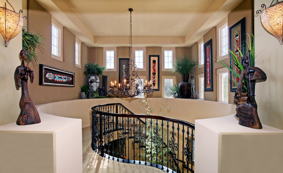 This is an example of a large eclectic entry hall in Orange County with white walls, carpet and beige floor.