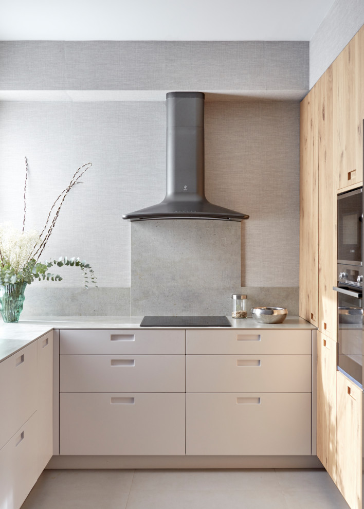 Design ideas for a mid-sized modern u-shaped open plan kitchen in Other with an undermount sink, light wood cabinets, terrazzo benchtops, grey splashback, granite splashback, panelled appliances, ceramic floors, no island, grey floor, green benchtop and flat-panel cabinets.