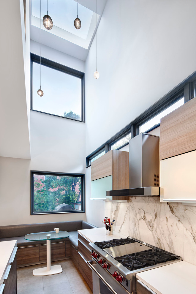 Inspiration for a mid-sized contemporary eat-in kitchen in New York with flat-panel cabinets, medium wood cabinets, quartz benchtops, white splashback, marble splashback, stainless steel appliances and cement tiles.