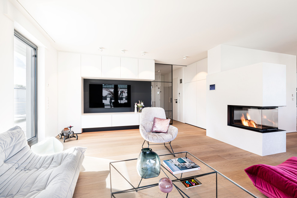 This is an example of a contemporary family room in Other with white walls, a corner fireplace, a plaster fireplace surround and beige floor.