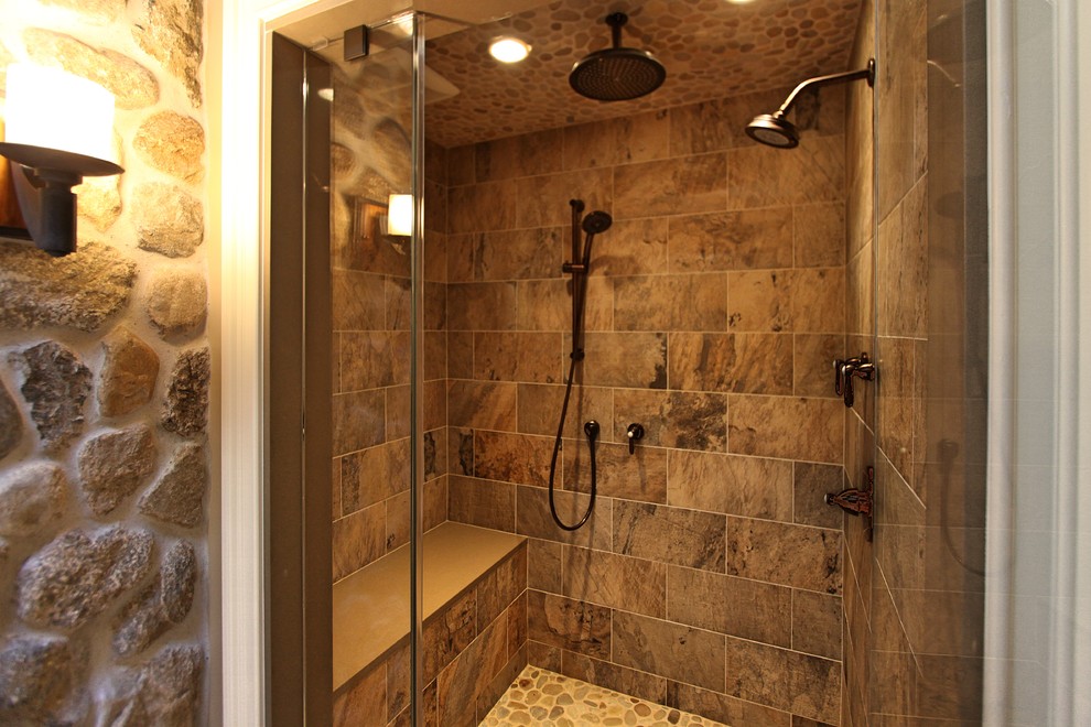 Photo of a large country master bathroom in New York with shaker cabinets, distressed cabinets, an alcove shower, a one-piece toilet, multi-coloured tile, porcelain tile, beige walls, pebble tile floors, an undermount sink, engineered quartz benchtops, multi-coloured floor and a hinged shower door.
