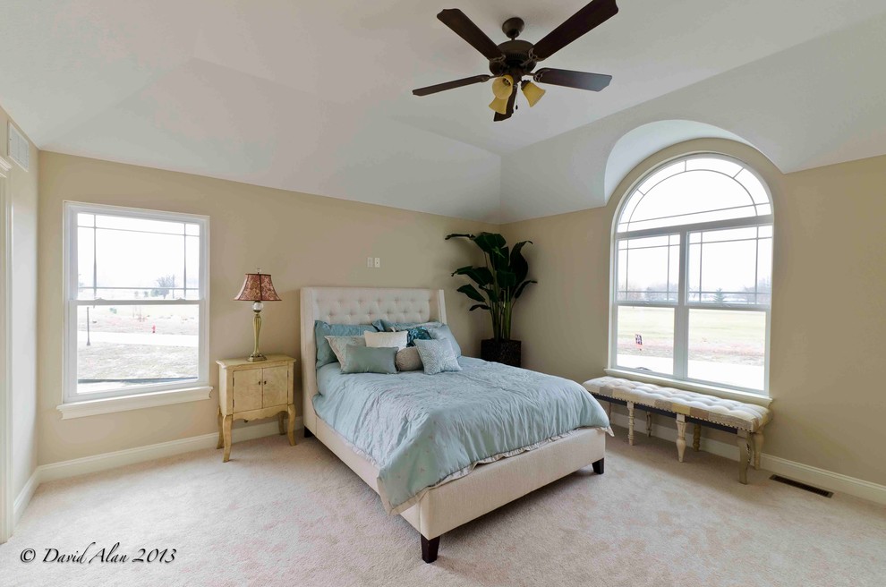 Inspiration for a large transitional guest bedroom in Cleveland with beige walls and carpet.